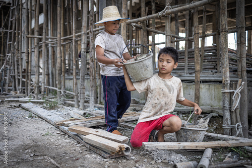 Concept of child labor, poor children being victims of construction labor, human trafficking, child abuse. © Tinnakorn
