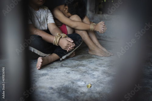  Child abuse concept, Child rights violations, violence against children and human trafficking. Human hands was tied with a rope, International human rights day concept. photo