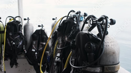 Scuba tanks stand prepped for adventure against a backdrop of a cloudy ocean sky photo