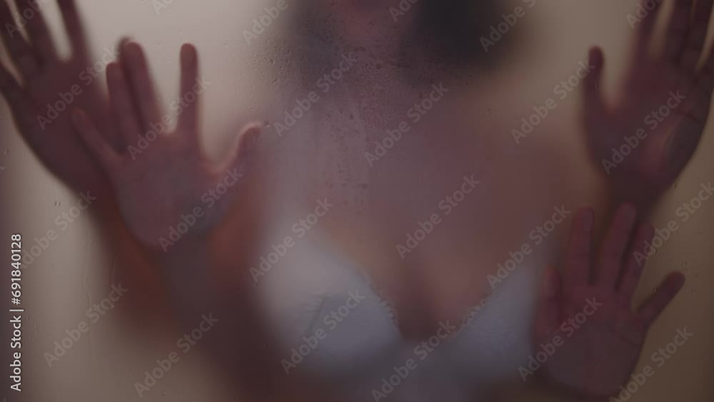 Young couple sexual bonding against a steamy mirror