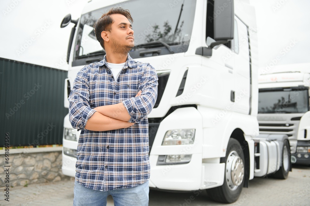 Young Indian truck driver. Concept of road freight transportation Young Indian truck driver. Concept of road freight transportation