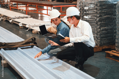 Metalwork manufacturing factory manager inspect newly manufactured metal or steel sheets and frame in factory. Inspection and quality control process ensure highest quality product. Exemplifying
