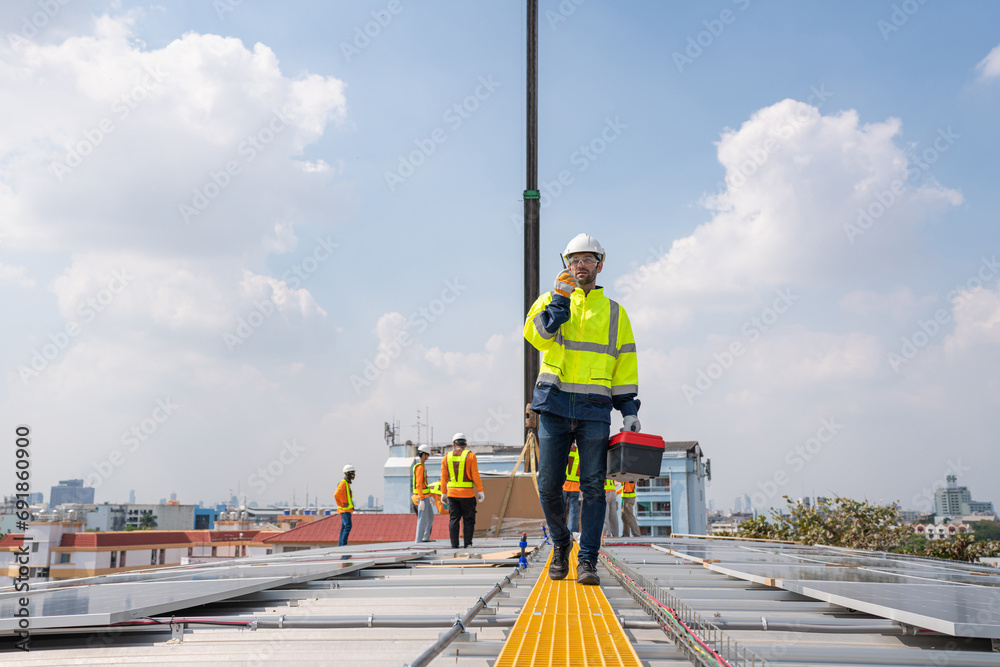 custom made wallpaper toronto digitalEngineers in helmets installing solar panel system outdoors. Installing a Solar Cell on a Roof. Solar panels on roof. Workers installing solar cell power plant eco technology.