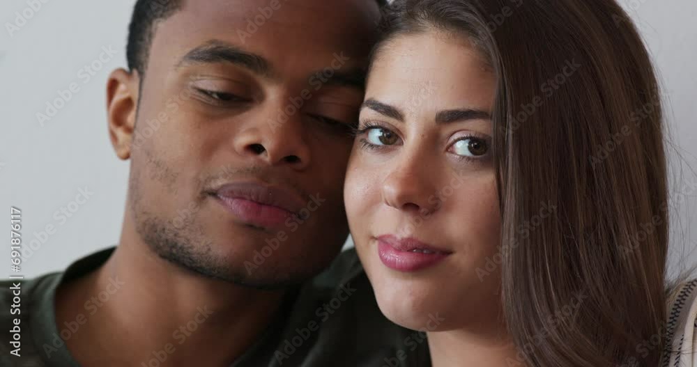 Close up portrait of black man giving his girlfriend a kiss on the cheek. White and African American millennial couple looking at camera. 4k slow motion handheld Close up portrait of black man giving his girlfriend a kiss on the cheek. White and African American millennial couple looking at camera. 4k slow motion handheld