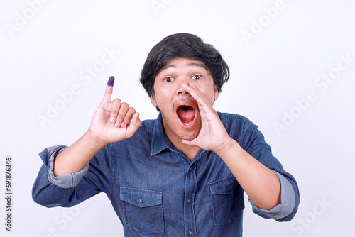 Excited young Asian man calling everyone after voting on Indonesia presidential election. Election ads concept photo