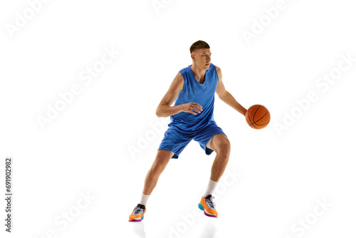 Young man in blue uniform playing baseball isolated over white background. Active hobby. Concept of professional sport, competition, match, championship, health, action. Ad