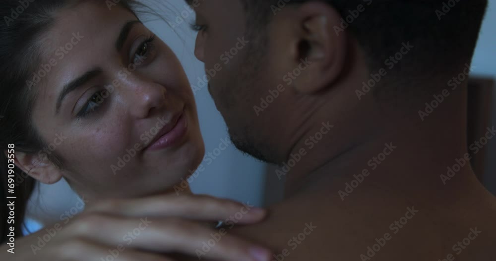 Close up of smiling young woman in love slow dancing with her boyfriend and looking up into his face. Happy millennial couple laughing and holding each other. 4k slow motion handheld