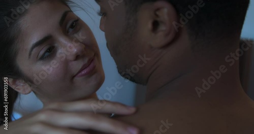 Close up of smiling young woman in love slow dancing with her boyfriend and looking up into his face. Happy millennial couple laughing and holding each other. 4k slow motion handheld