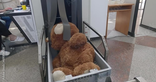 Airport Scan Checked Luggage. X-ray luggage screening machine. Teddy Bear Soft Toy photo