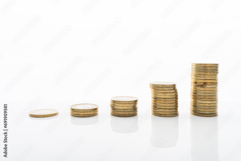 Coins stacked on white backgroud with smooth reflection. Concept of grow, investment, saving money. Coins stacked on white backgroud with smooth reflection. Concept of grow, investment, saving money.