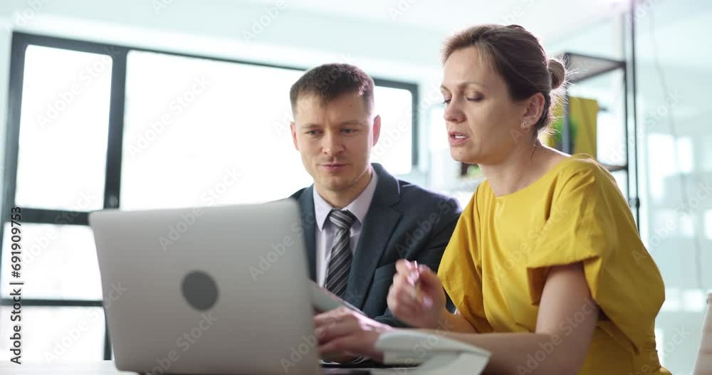 A man and a woman in the office discuss information on the laptop screen, a close-up. Brainstorming, timelapse A man and a woman in the office discuss information on the laptop screen, a close-up. Brainstorming, timelapse