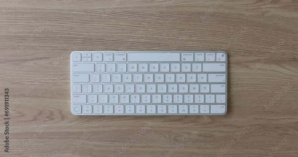 Hand and keyboard spacebar on table. Spacebar long horizontal key at bottom of keyboard Hand and keyboard spacebar on table. Spacebar long horizontal key at bottom of keyboard