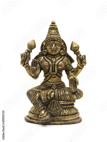 hindu goddess mahalakshmi antique idol with four hands isolated in a white background