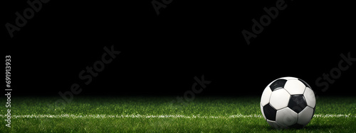 soccer ball on grass with dark background, closeup, banner, copy space for text © CreativeBB