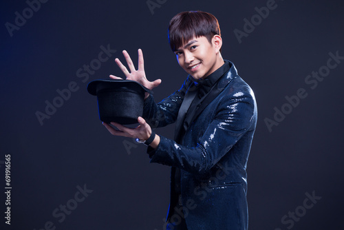Young magician performing magic trick photo