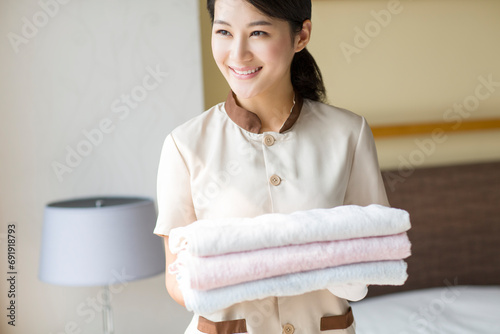 Domestic staff cleaning bedroom photo