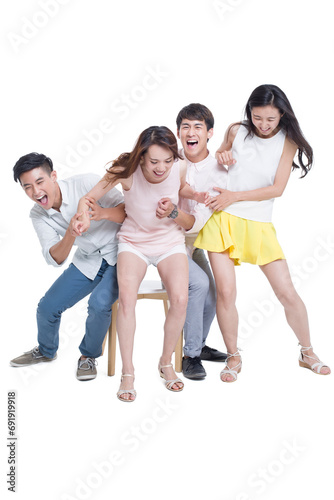 Young adults playing musical chairs photo