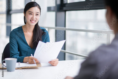 Young businesswoman conducting job interview photo