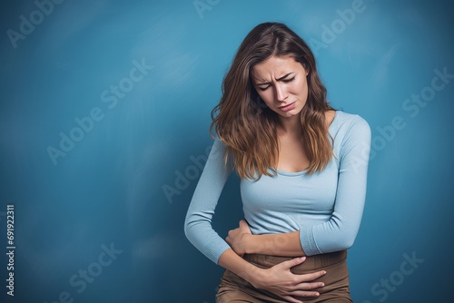 woman in pain holding her belly, stomach ache photo