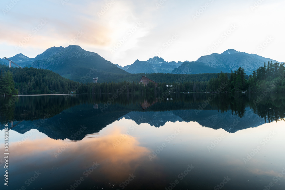Strbske pleso lake with peaks above in High Tatras mountains in Slovakia during early morning before sunrise