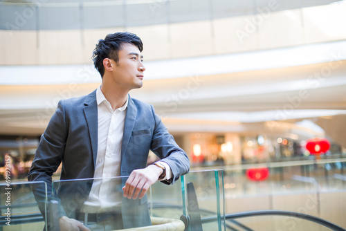 Young man standing in shopping mall photo