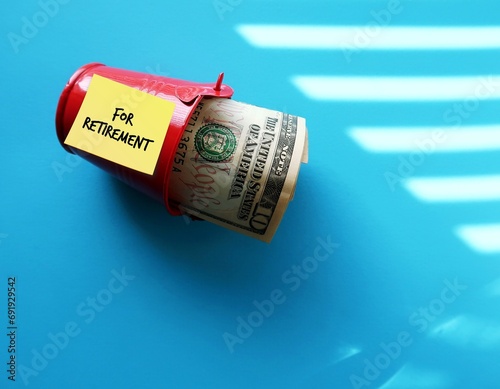 Note stick on red saving tub with text written FOR RETIREMENT, concept of financial management, start planning to save and invest for retirement