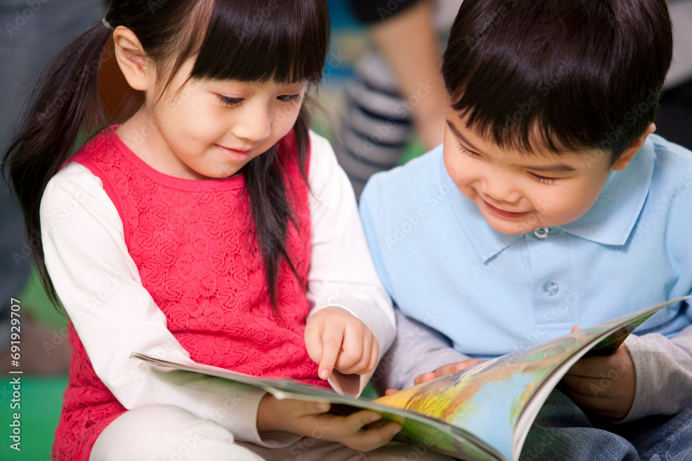 Cute little girl and little boy reading books Cute little girl and little boy reading books