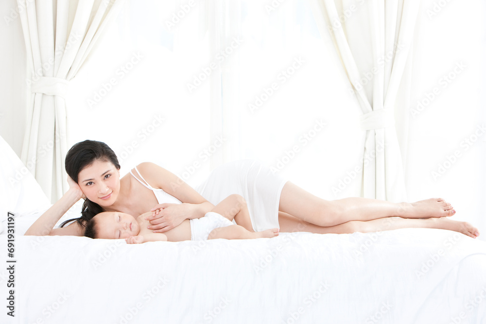 Gentle mother with sleeping baby Gentle mother with sleeping baby