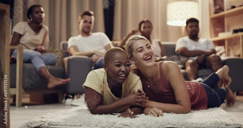 Friends, watching tv and living room with group with laughing, bonding and conversation at home. Couch, chat and diversity of people together with movie, film and relax in a lounge with discussion photo