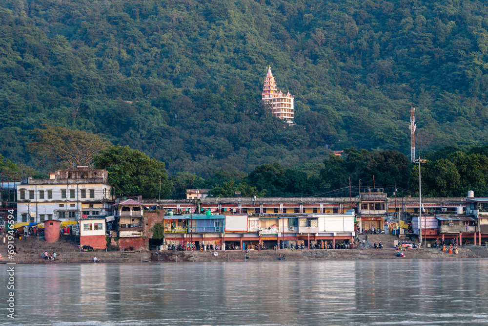views of rishikesh city crossed by ganges river, india