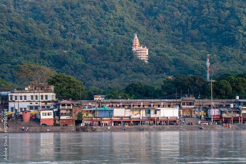 views of rishikesh city crossed by ganges river, india photo