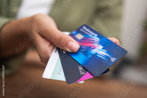close up woman hand holding heap of credit cards, online payment shopping banking, contactless Credit cards photo