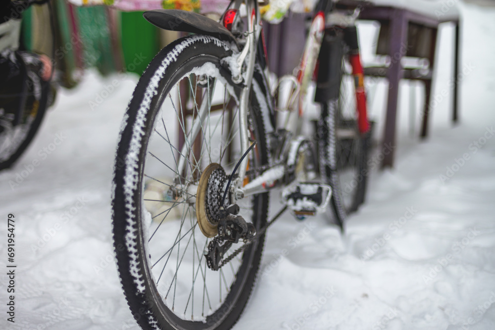Rear wheel of a mountain bike in the snow.