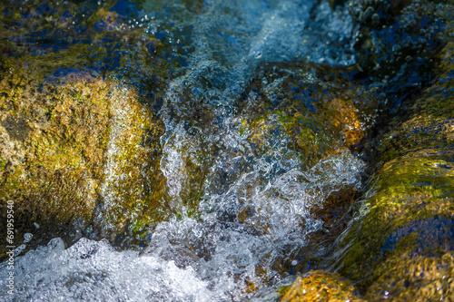 mountain stream. the sound of flowing water. The mesmerizing dance of water and stones creates an oasis of calm where stress simply melts away. Enchantment of Nature