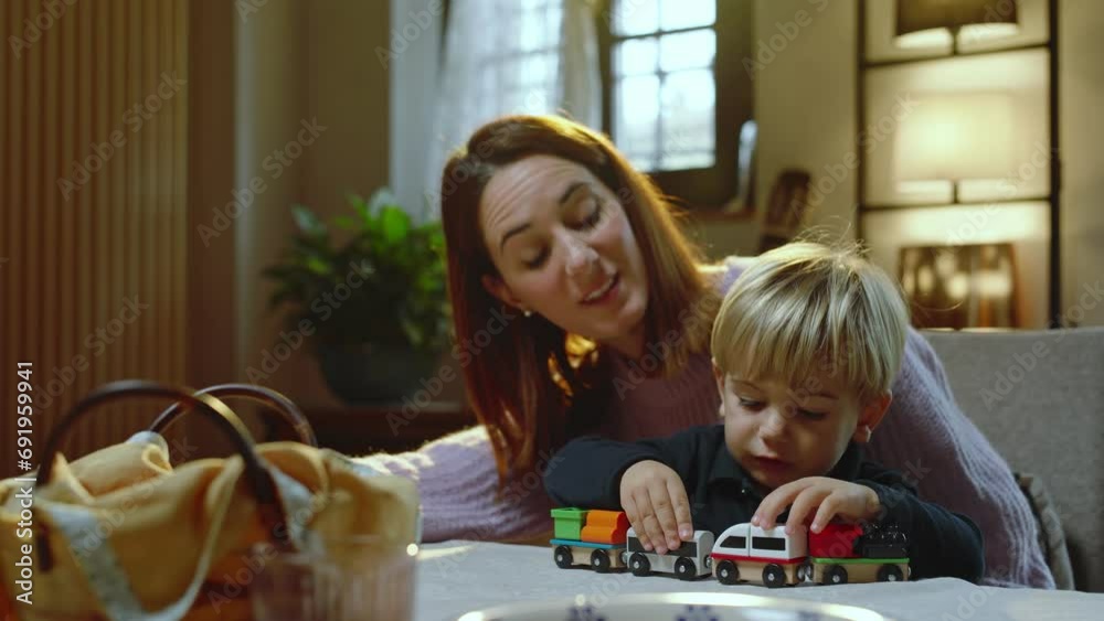 To entertain her son at the table, a young mother lets him play with a wooden train.
The mother and the child play and are happy To entertain her son at the table, a young mother lets him play with a wooden train.
The mother and the child play and are happy