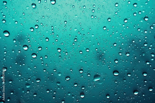  a close up view of water droplets on a window with a blue sky in the background and clouds in the background.