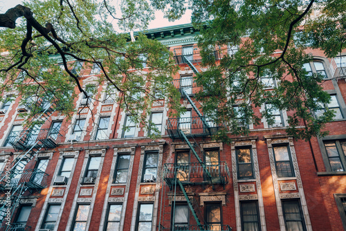 Facade of a typical New York block of flats with fire escape at the front, USA. photo