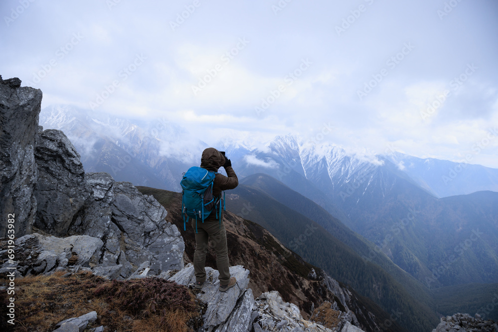 Successful woman hiker hiking at mountain top in tibet Successful woman hiker hiking at mountain top in tibet