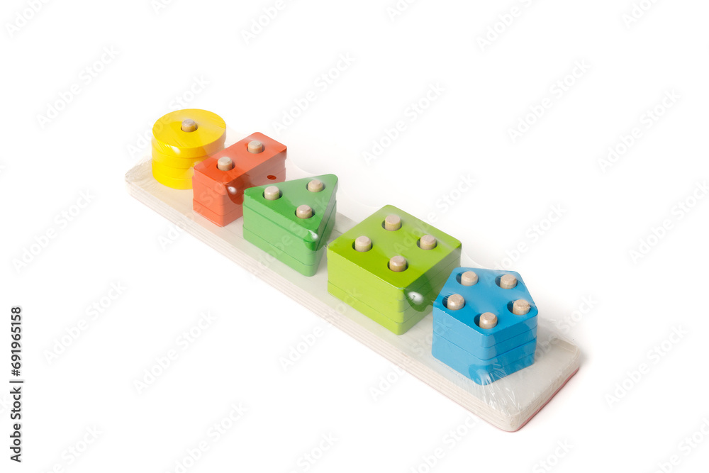 New children's wooden educational toy packed in polyethylene on a white background. New children's wooden educational toy packed in polyethylene on a white background.