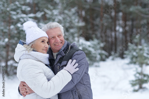Happy senior couple at snowy winter park
