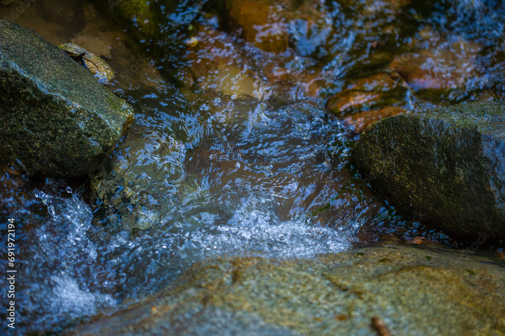 water in a mountain stream. Feel the tranquility of a mountain stream. Immerse yourself in the soothing sounds of nature. Find peace and solace in the wild.