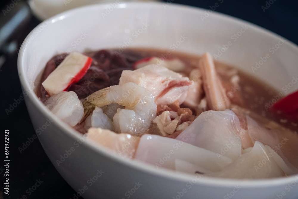 Thai style traditional cuisine is raw pork or seafood marinated for Thai style barbecue grill or Moo Krata