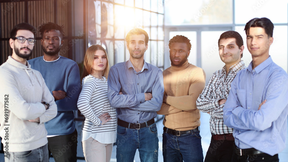 Fototapeta premium Positive multi racial corporate team posing looking at camera