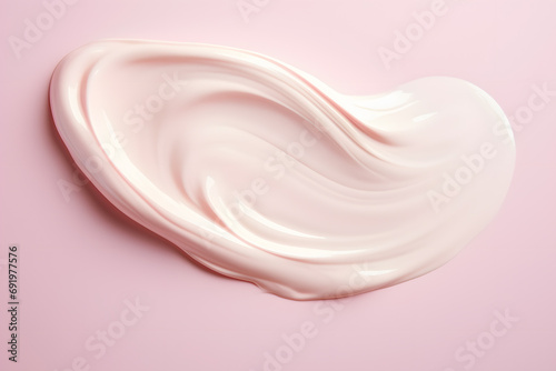 Face moisturizing cream smudge on pink background
