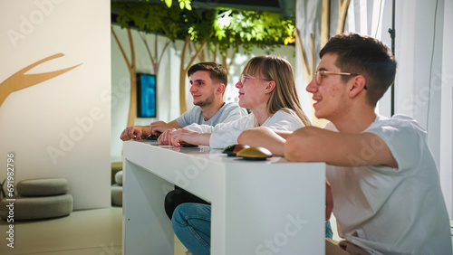 Students at a Quiz Competition with Hands on a Button photo