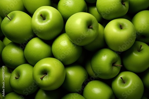  a pile of green apples with one green apple in the middle of the pile and one green apple in the middle of the pile.