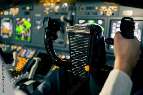 close-up Pilot in the cockpit of an airplane holding a rotary steering wheel during a flight Air travel concept photo