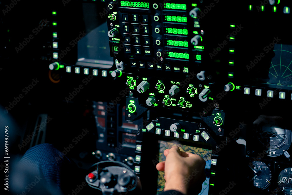 Fototapeta premium close-up hand of the pilot captain presses the buttons on the control panel to start the engine of the plane Flight simulator close-up