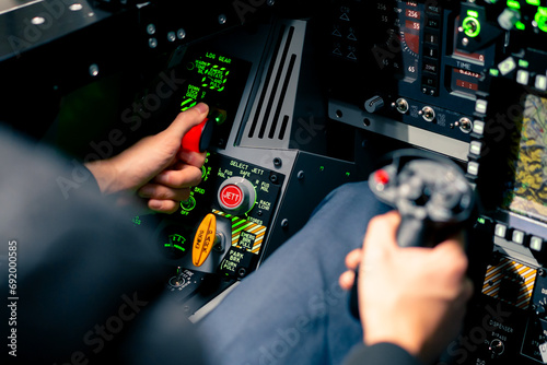 close-up of the cockpit of a military plane a pilot with a steering wheel and many buttons on the control panel of an airplane flight simulator photo