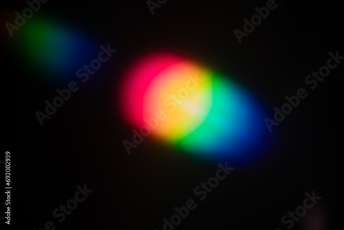 Multi-colored lens flare bokeh. A rainbow flare is similar to the flare on a photographic film. Abstract Bright Overlay Element